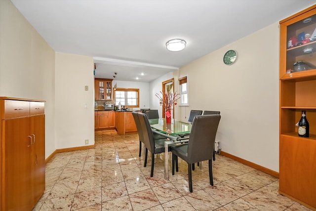 dining area with marble finish floor and baseboards