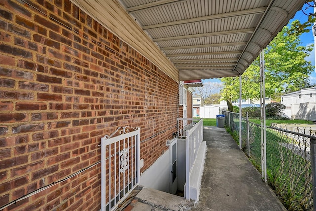 view of home's exterior featuring fence and brick siding