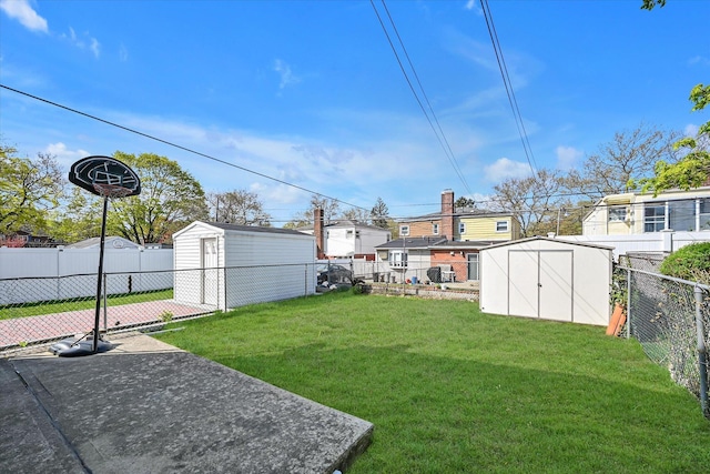 view of yard with an outbuilding, a shed, and a fenced backyard