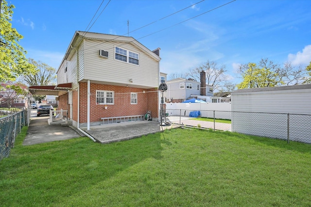 rear view of house with a lawn, fence private yard, a patio, and brick siding