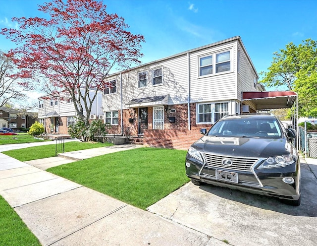 view of property with a carport, a front yard, and brick siding