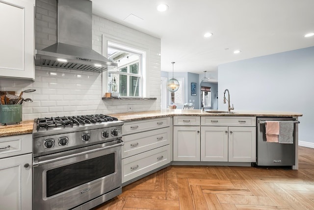 126 Lincoln Ave E, West Harrison, NY 10604 - kitchen featuring light stone counters, decorative backsplash, stainless steel appliances, a sink, and wall chimney exhaust hood