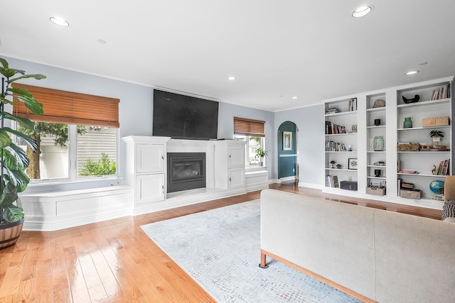 126 Lincoln Ave E, West Harrison, NY 10604 - living area with a glass covered fireplace, recessed lighting, light wood finished floors, and arched walkways