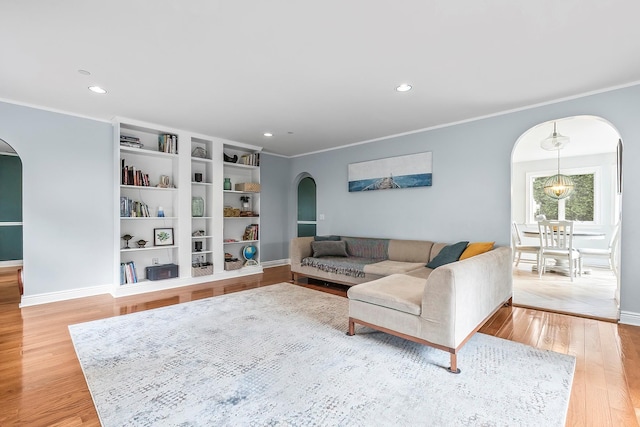126 Lincoln Ave E, West Harrison, NY 10604 - living room featuring crown molding, light wood finished floors, baseboards, and arched walkways
