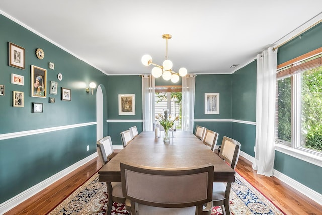 126 Lincoln Ave E, West Harrison, NY 10604 - dining room featuring wood finished floors, an inviting chandelier, arched walkways, and plenty of natural light