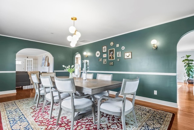 126 Lincoln Ave E, West Harrison, NY 10604 - dining space featuring baseboards, visible vents, arched walkways, and wood finished floors