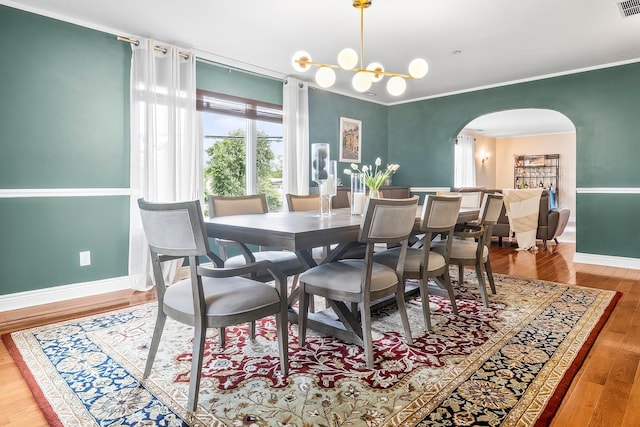126 Lincoln Ave E, West Harrison, NY 10604 - dining area with arched walkways, wood finished floors, ornamental molding, baseboards, and visible vents