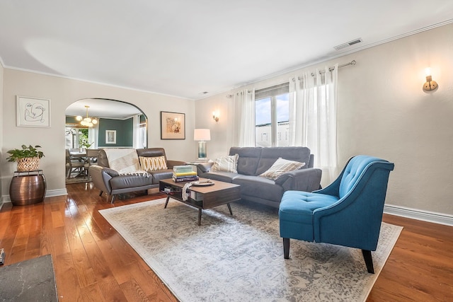 126 Lincoln Ave E, West Harrison, NY 10604 - living room featuring visible vents, hardwood / wood-style flooring, ornamental molding, and arched walkways
