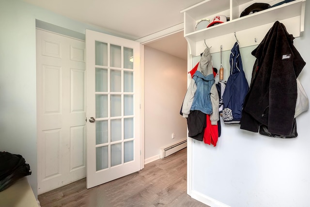126 Lincoln Ave E, West Harrison, NY 10604 - mudroom with wood finished floors, a baseboard heating unit, and baseboards