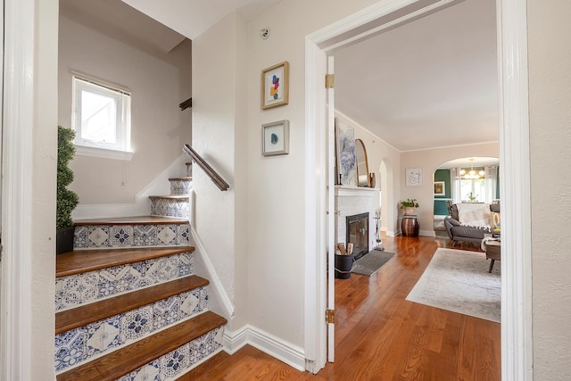 126 Lincoln Ave E, West Harrison, NY 10604 - stairs with baseboards, wood finished floors, arched walkways, and plenty of natural light