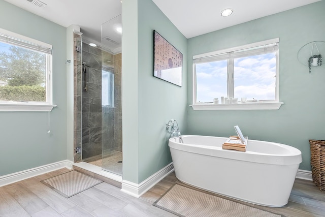 126 Lincoln Ave E, West Harrison, NY 10604 - full bathroom with a stall shower, a wealth of natural light, and baseboards