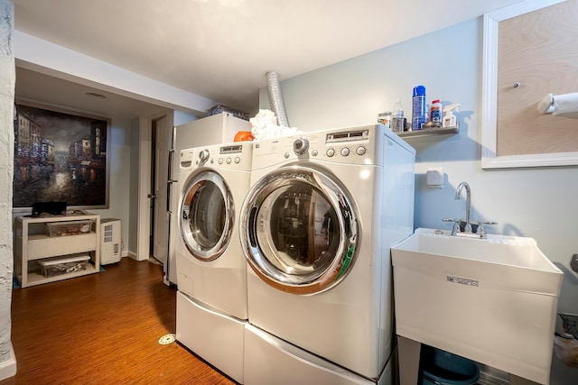 126 Lincoln Ave E, West Harrison, NY 10604 - laundry room featuring a sink, laundry area, wood finished floors, and washer and clothes dryer