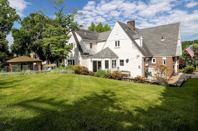 126 Lincoln Ave E, West Harrison, NY 10604 - rear view of property featuring brick siding, fence, a yard, and a chimney