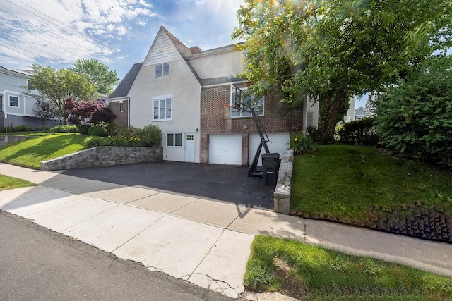 126 Lincoln Ave E, West Harrison, NY 10604 - view of front facade with a garage, brick siding, aphalt driveway, and a front lawn