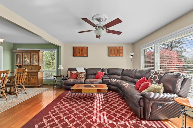 living room featuring wood finished floors and a ceiling fan