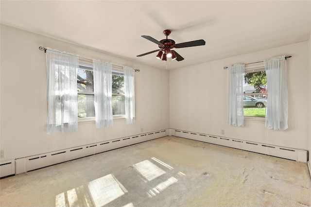 carpeted empty room with a ceiling fan