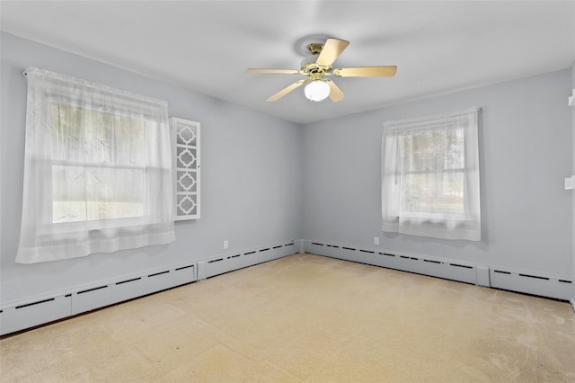 unfurnished room with a ceiling fan, a wealth of natural light, and light colored carpet