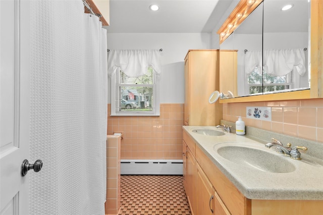 full bath featuring a sink, a baseboard radiator, tile walls, and tile patterned floors