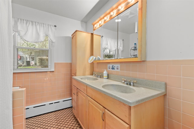 full bath with a sink, wainscoting, tile walls, and baseboard heating