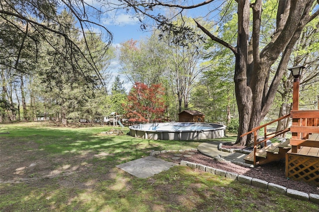 view of yard featuring an outdoor pool