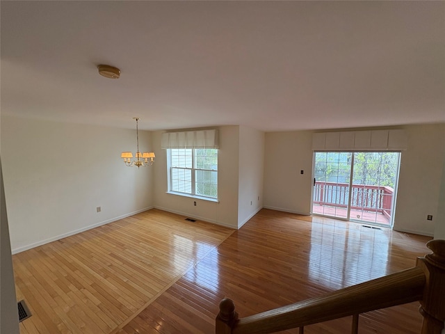 115 Turnberry Ct, Poughkeepsie, NY 12603 - empty room featuring baseboards, visible vents, light wood-style flooring, and a chandelier