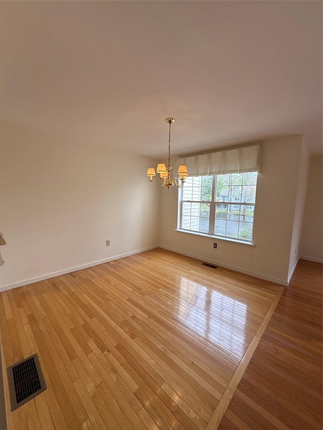 115 Turnberry Ct, Poughkeepsie, NY 12603 - unfurnished dining area featuring light wood-style floors, baseboards, a notable chandelier, and visible vents
