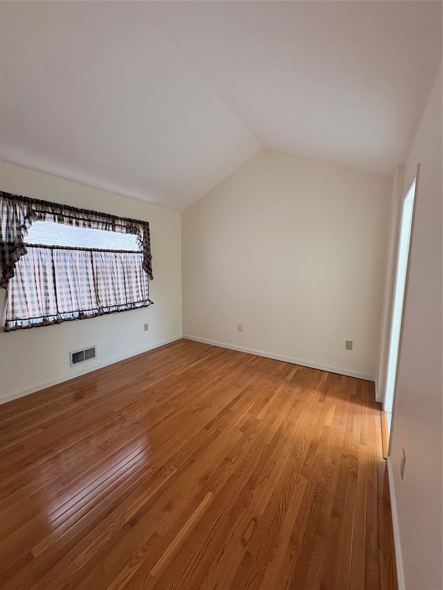 115 Turnberry Ct, Poughkeepsie, NY 12603 - empty room featuring baseboards, lofted ceiling, wood finished floors, and visible vents