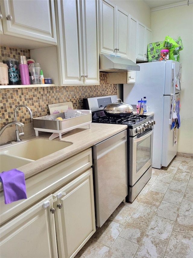 kitchen with decorative backsplash, a sink, stainless steel appliances, light countertops, and under cabinet range hood