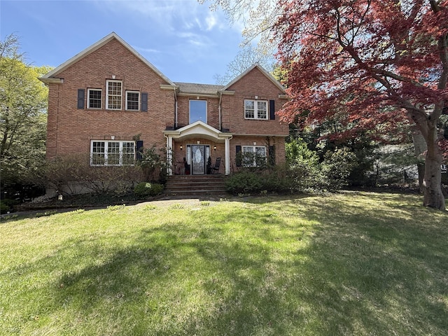 traditional-style house with brick siding and a front yard