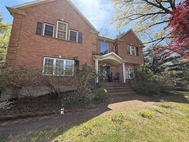 traditional-style house featuring brick siding