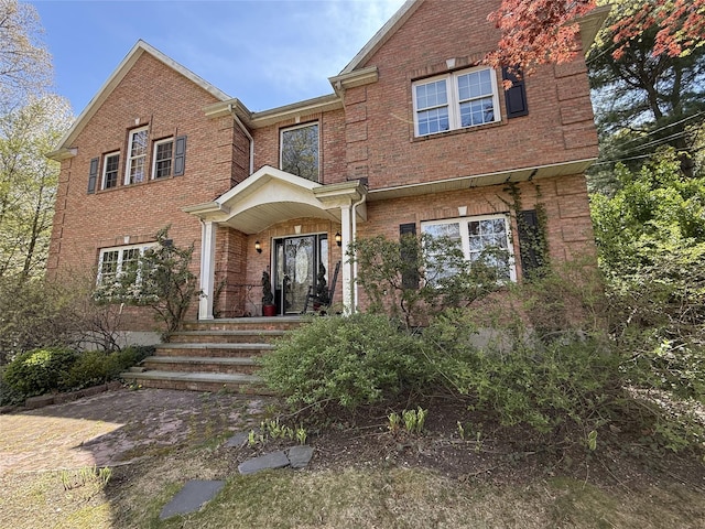 traditional-style house with a porch and brick siding