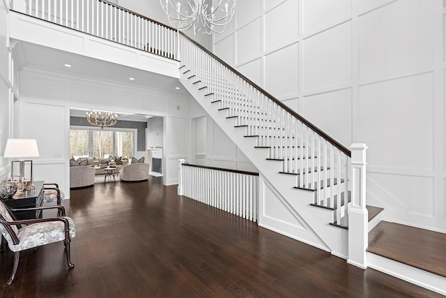471 Middle Line Hwy, Sag Harbor, NY 11963 - stairway with an inviting chandelier, a decorative wall, and wood finished floors