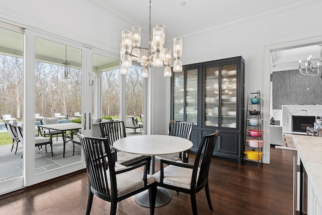 471 Middle Line Hwy, Sag Harbor, NY 11963 - dining room featuring a chandelier, a healthy amount of sunlight, dark wood finished floors, and crown molding