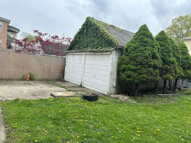 detached garage featuring fence