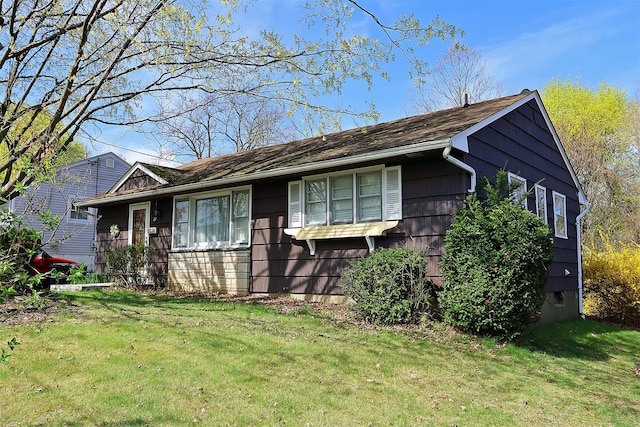 ranch-style home with a front lawn