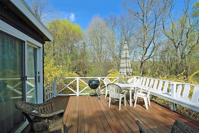wooden deck featuring outdoor dining area