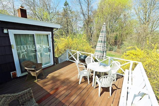 wooden deck with outdoor dining space