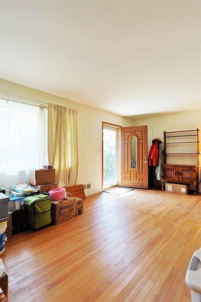 living area with visible vents and hardwood / wood-style flooring