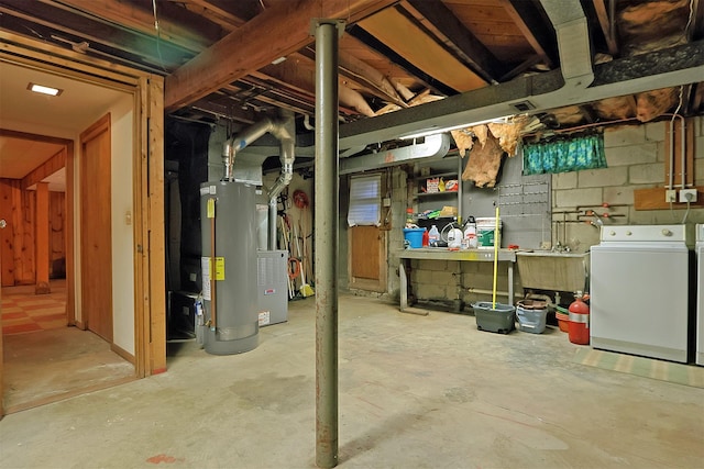 unfinished basement featuring gas water heater, washing machine and dryer, a sink, and a workshop area