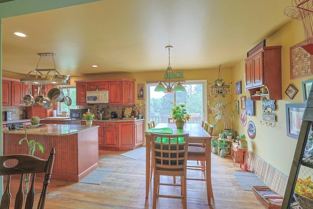 15 Hickory Hill Dr, Warwick, NY 10990 - kitchen with white microwave, plenty of natural light, light wood-style floors, decorative backsplash, and recessed lighting