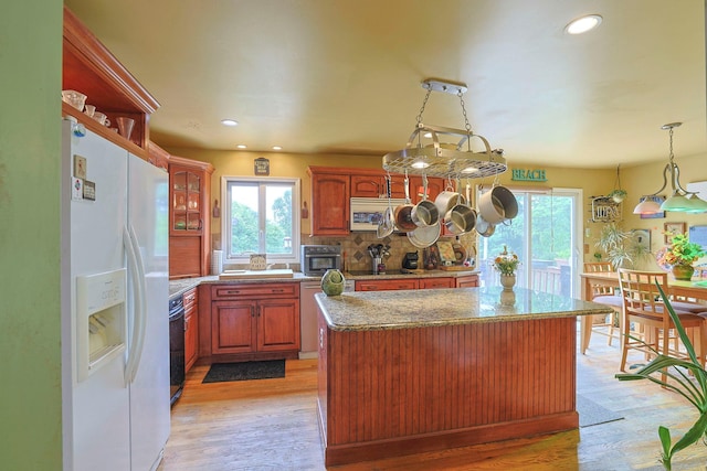 15 Hickory Hill Dr, Warwick, NY 10990 - kitchen with white fridge with ice dispenser, a center island, backsplash, light wood-style flooring, and black electric cooktop