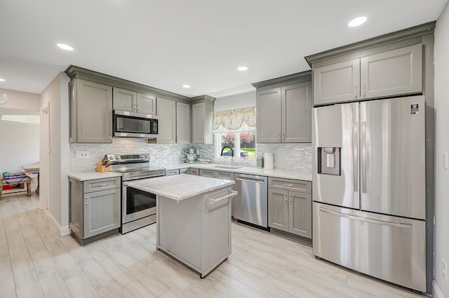 kitchen featuring gray cabinetry, backsplash, and appliances with stainless steel finishes
