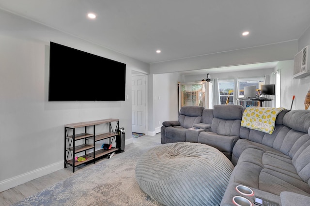 living room featuring recessed lighting, a wall mounted AC, a chandelier, light wood-type flooring, and baseboards