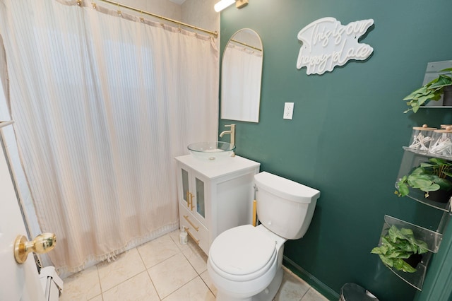 bathroom with tile patterned floors, curtained shower, toilet, and vanity