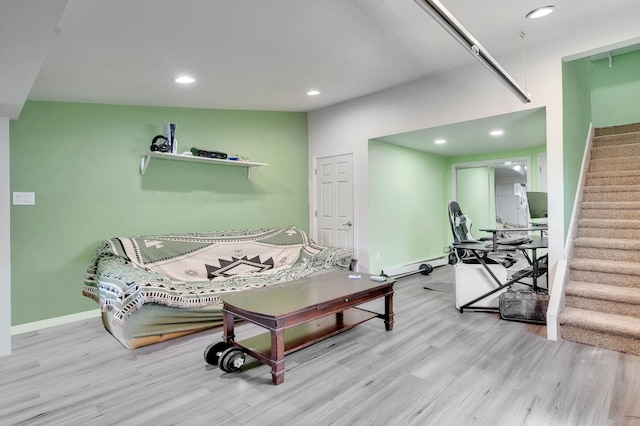 living area featuring stairway, wood finished floors, recessed lighting, and baseboard heating