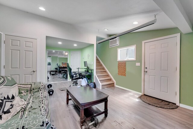 living room with wood finished floors, recessed lighting, stairs, and baseboards