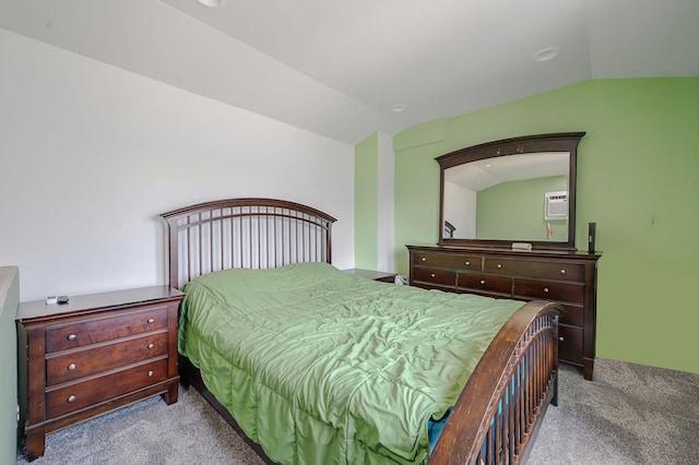 bedroom featuring a wall mounted air conditioner, carpet, and vaulted ceiling