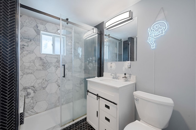 bathroom with a stall shower, toilet, and vanity