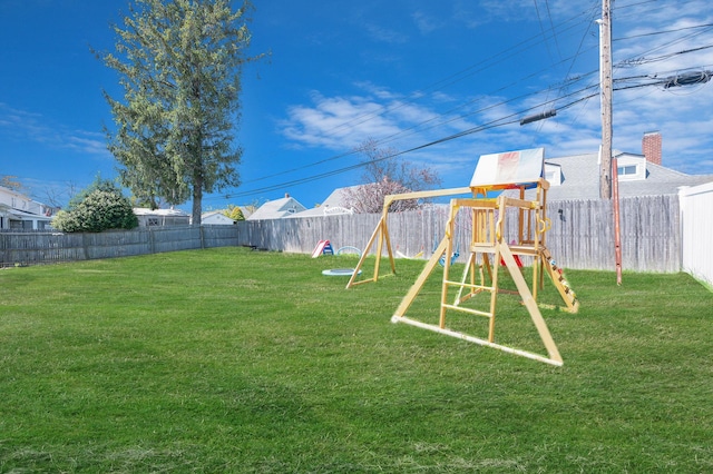 view of yard with a fenced backyard and a playground