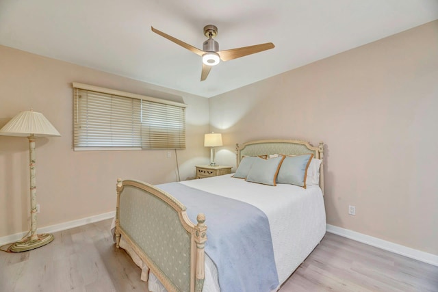 bedroom with baseboards, ceiling fan, and wood finished floors